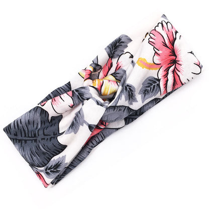 Floral cross hair band with patterned fabric design, shown against a clean background