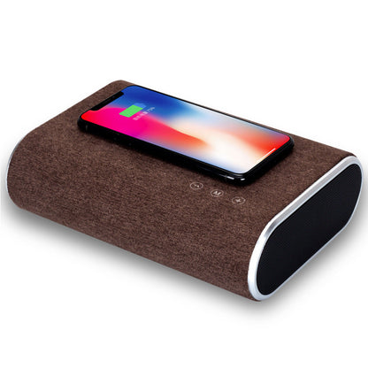 Wireless charger speaker with compact black design and integrated charging pad