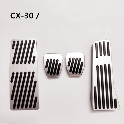 Metal throttle and brake pedal covers, close-up view