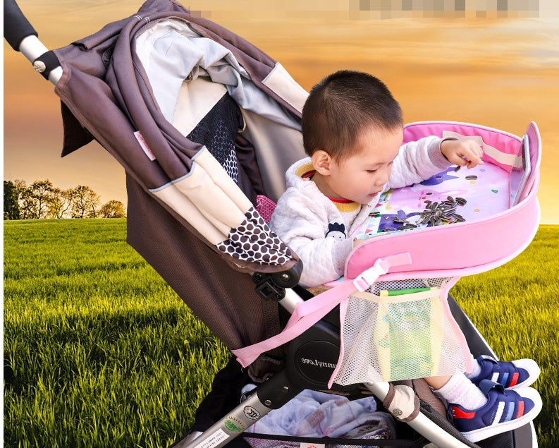 Baby car seat tray table with cup holder and activity surface, shown in black and gray.