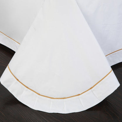 Four-piece cotton bedding set in soft fabric with fitted sheet, flat sheet, and pillowcases folded neatly