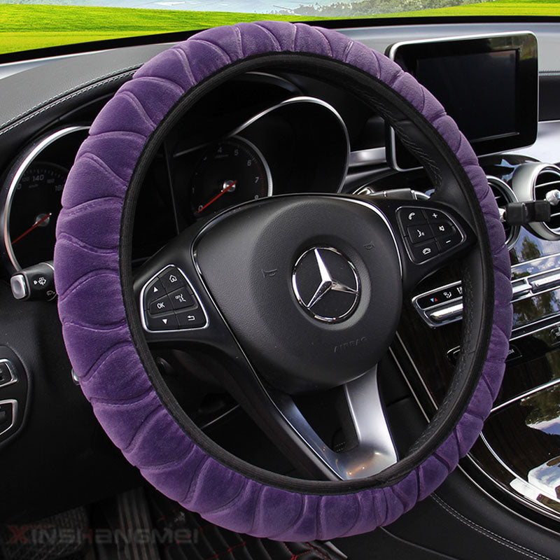 Plush car steering wheel cover in soft fabric, showing a cozy textured design around the wheel