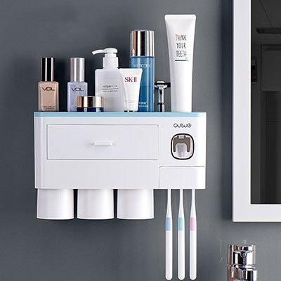 Non-marking hanging magnetic toothbrush holder with single drawer, toothpaste squeezer, and toiletry storage rack