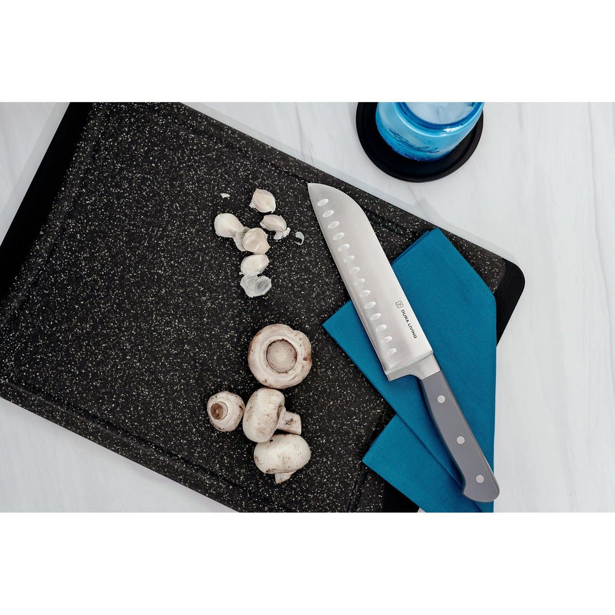 Dura Living Superior 7-inch gray Santoku Knife with a stainless steel blade and ergonomic handle for precise slicing and chopping.
