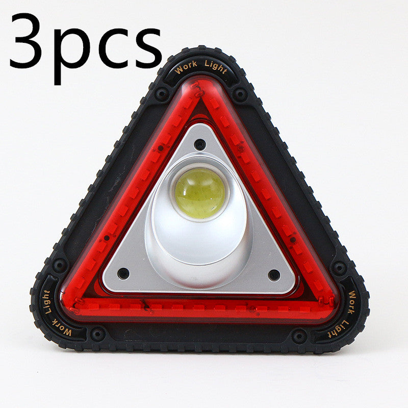 Triangular red warning light displayed on a plain background