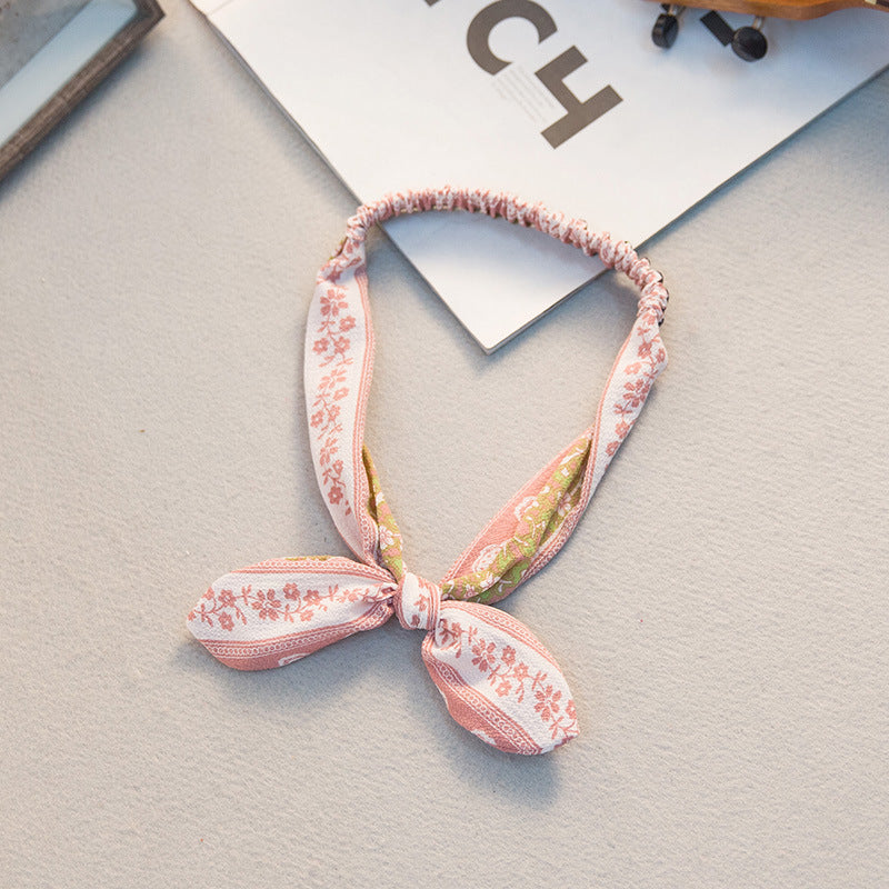 Big bow tie bunny ears headband with oversized bow detail and soft rabbit ear design