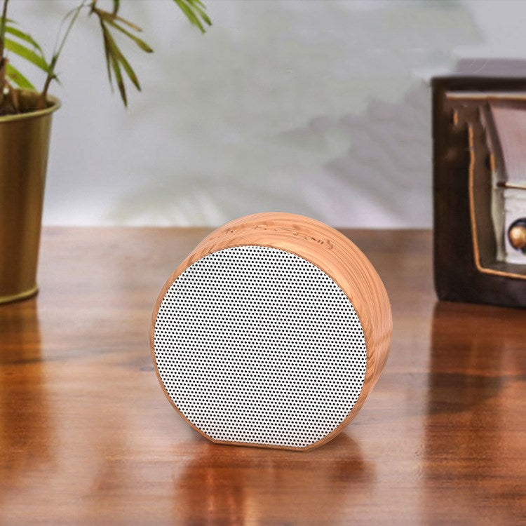 Wood grain Bluetooth speaker with compact wireless design and natural wood finish