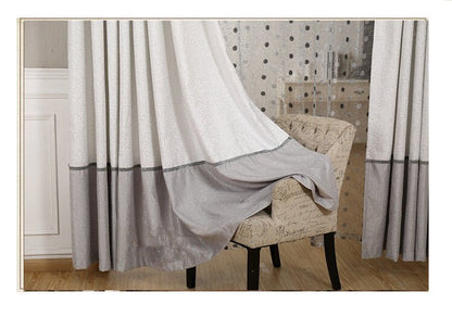 Simple blackout curtains in a solid color, shown hanging over a window