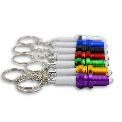 LED light spark plug keychain with compact metallic design and integrated light