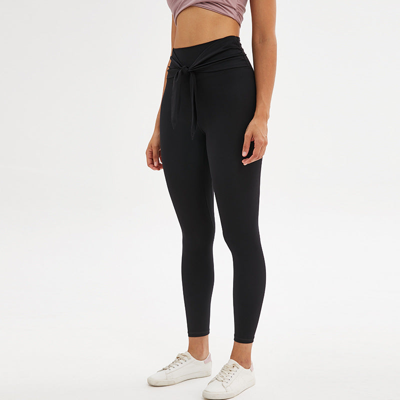 Nine-point legging yoga pants with straps in black, side view