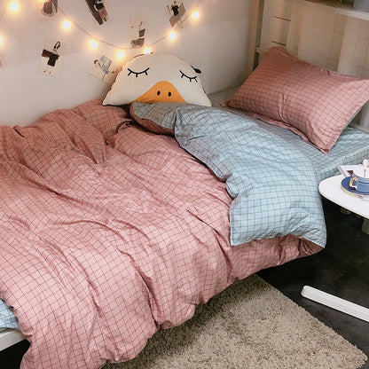 Four-piece Japanese bedding set with soft fabric layers in neutral colors, arranged neatly for a clear product view