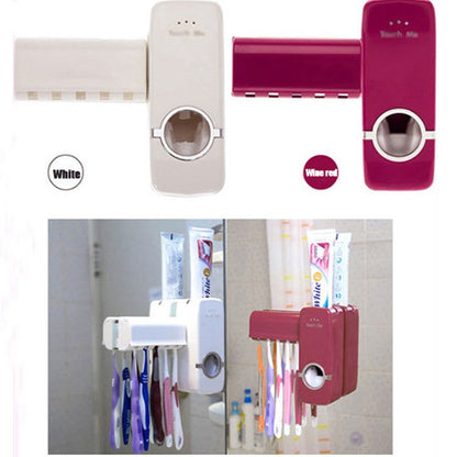 Automatic toothpaste squeezer dispenser mounted on a bathroom wall with toothpaste tube inserted