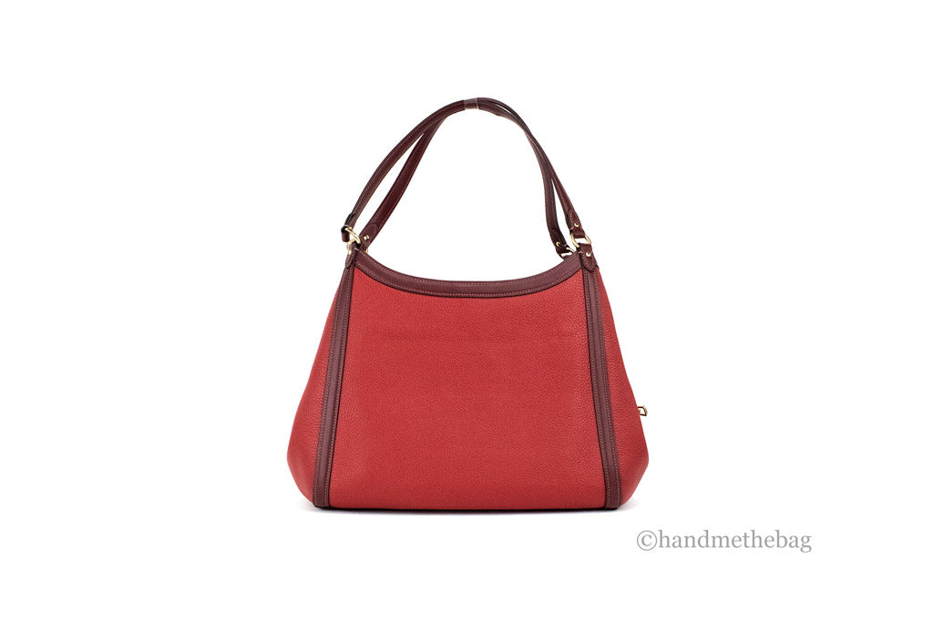 Coach Kristy red apple leather shoulder bag with triple compartments, stylish and spacious for everyday use.