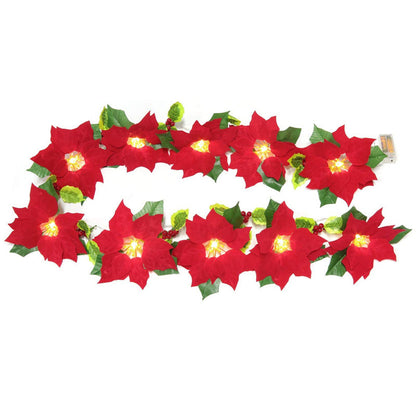 Red flower string lights decorating a door frame and escalator railing