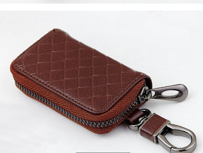 Men's leather car key case with woven design, shown closed with key ring and button fastening