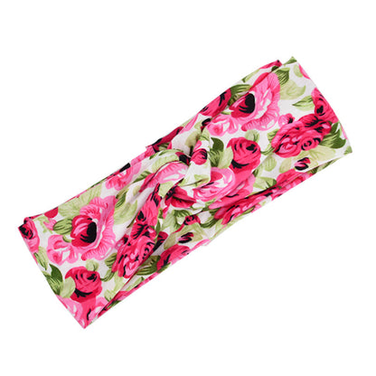 Floral cross hair band accessory with delicate flower design.