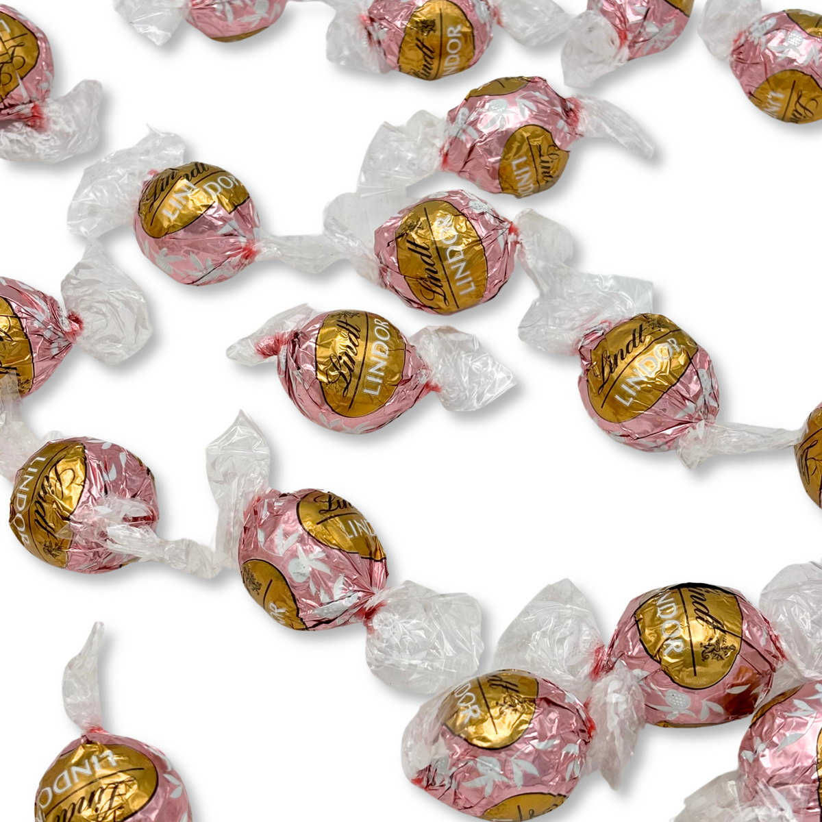 Lindt LINDOR Neapolitan white chocolate truffles in a bulk Candy In Bulk bag, showcasing creamy white, pink, and brown truffle varieties.