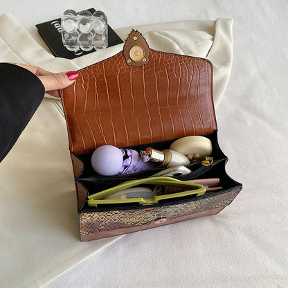Retro underarm bag with chain strap and crocodile pattern, viewed from the side
