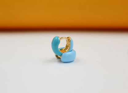 18K gold filled enamel small huggie earrings by MIA Jewelry, showcasing vibrant colored enamel on shiny gold hoops.