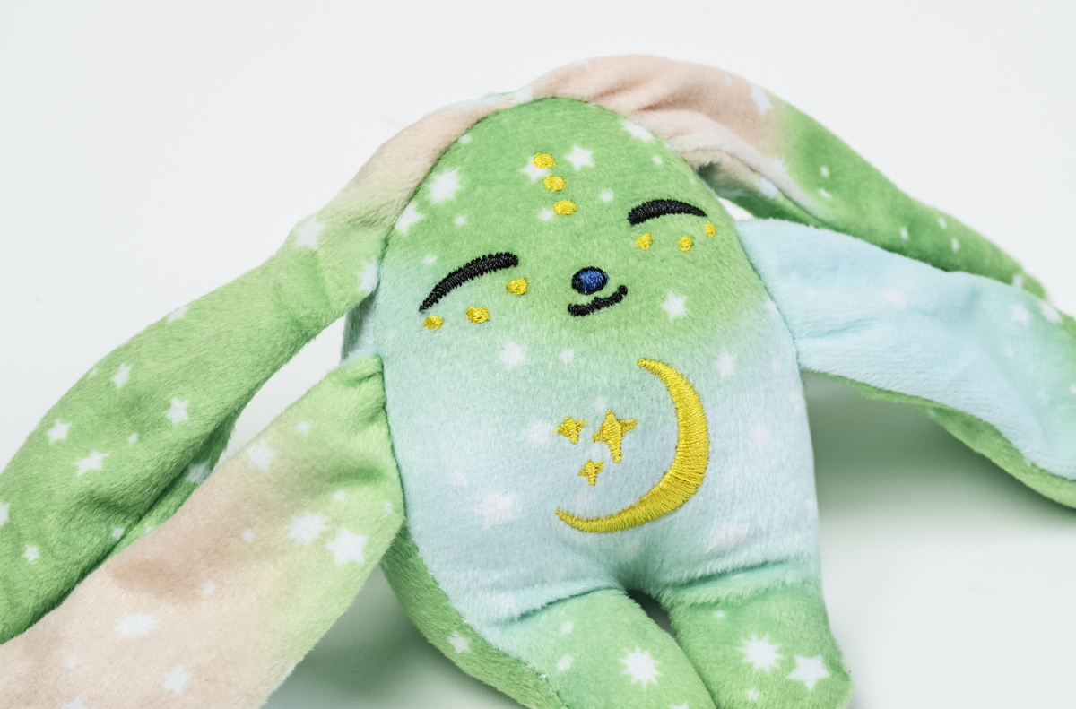 Moon Pals Clover Mini Wrist Hugger plush toy with soft, colorful fabric and adorable design for comfortable wear.