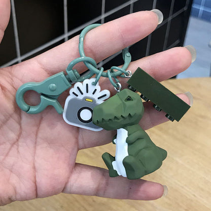 Cute dinosaur keychain key ring in a playful fashion design, displayed against a plain background