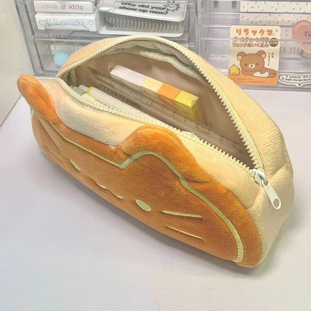 Cute caramel cat pencil case with cartoon design, zipper closure, and spacious storage compartments