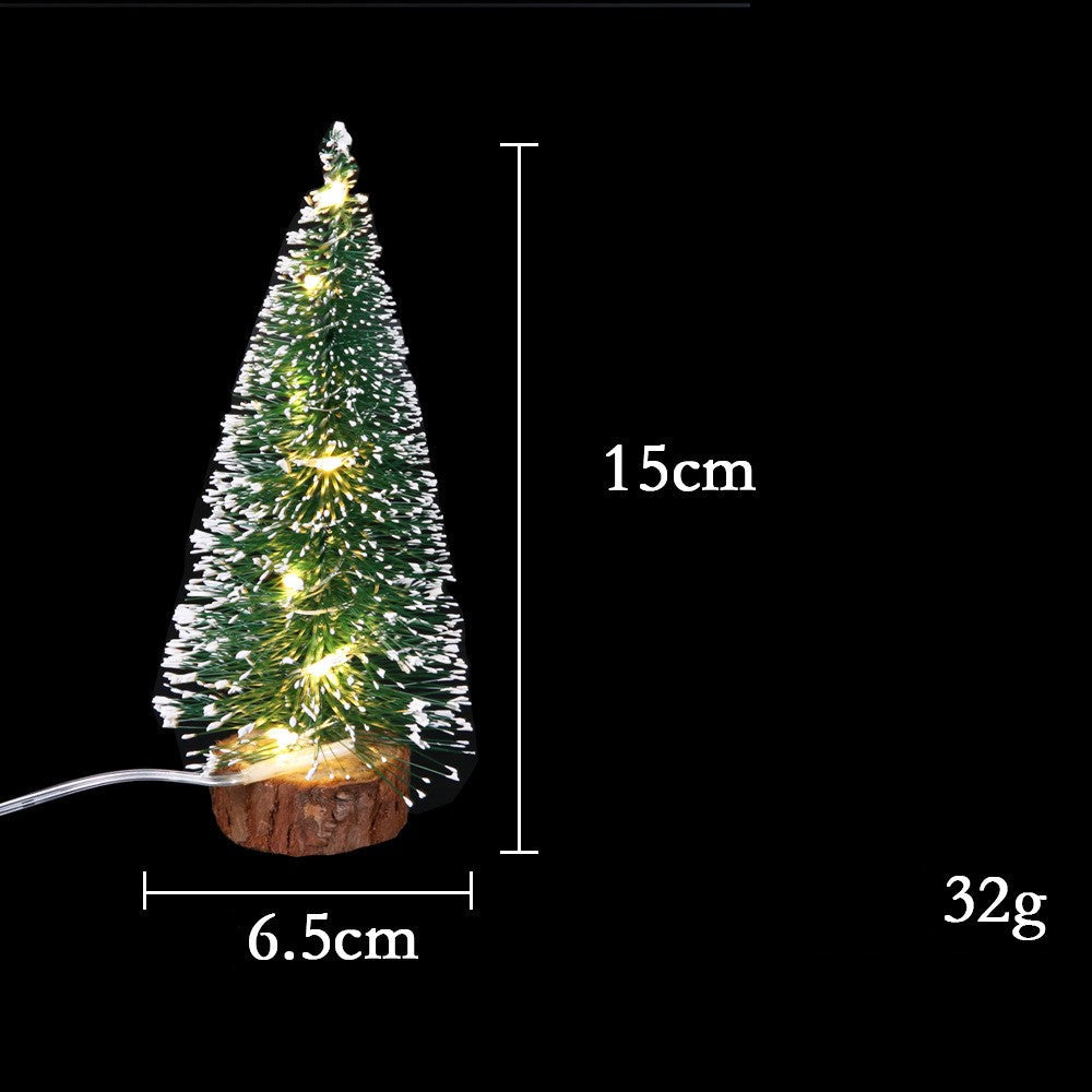 Mini Christmas tree with Christmas decorations and LED lights visibly glowing on the branches