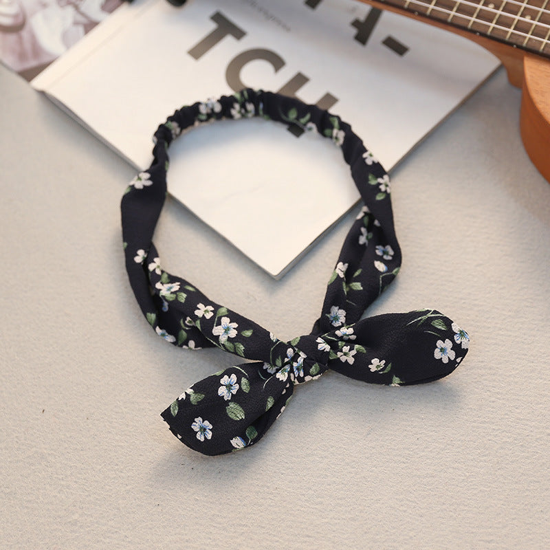 Big bow tie bunny ears headband in a playful design