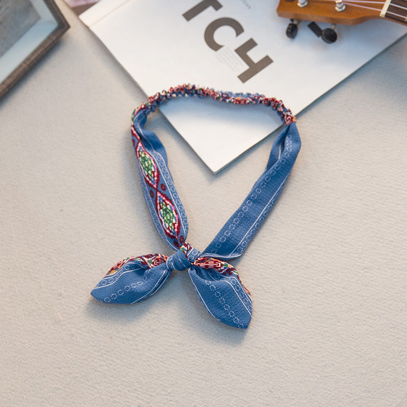 Big bow tie bunny ears headband by My Store on a plain background