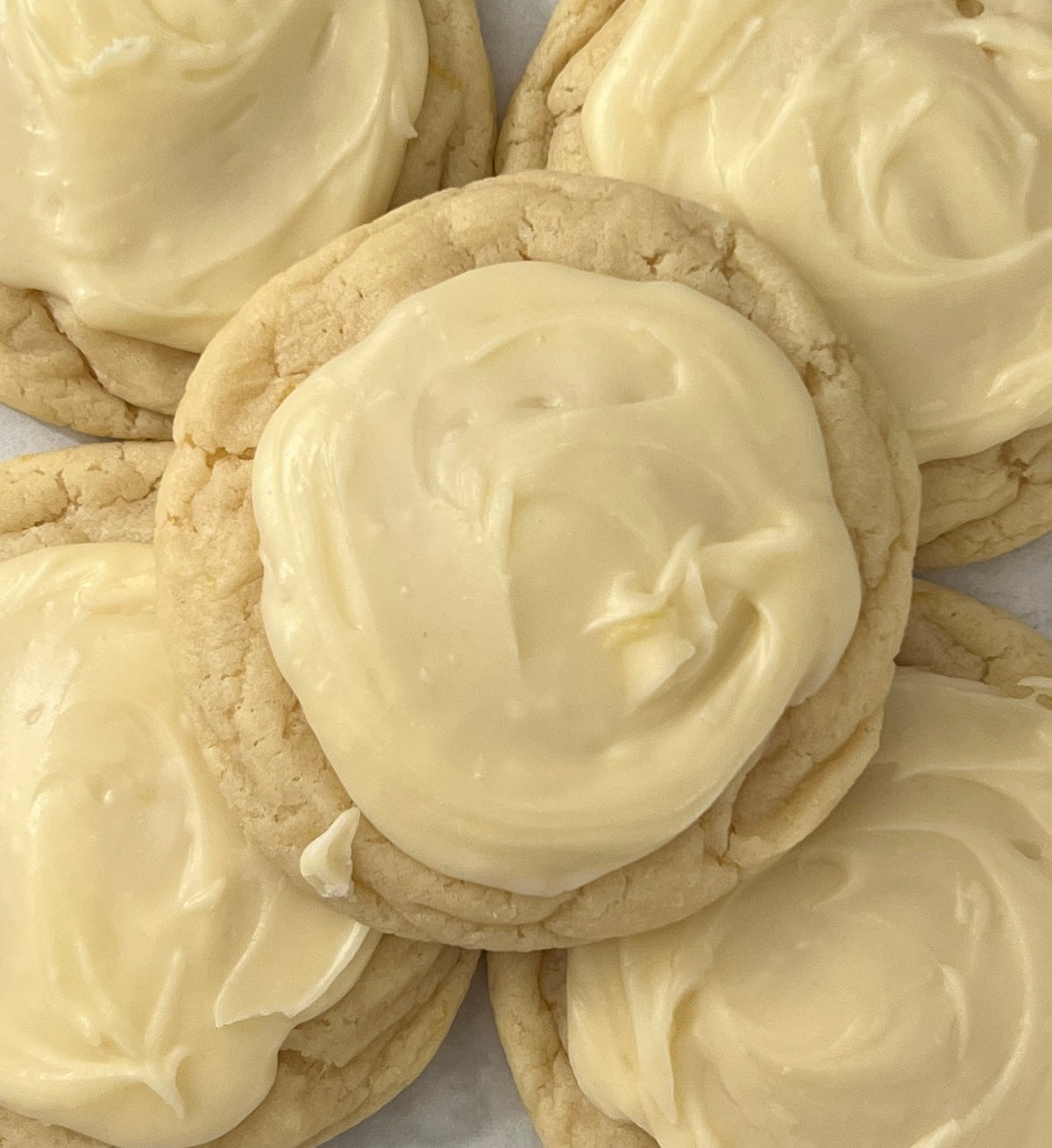 Lemon glazed cookies from Let's Get Baked Artisan Desserts, featuring shiny lemon glaze and golden-brown cookie base.
