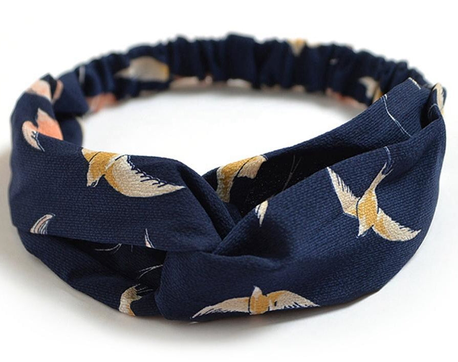 Women's retro style printed headband with colorful patterned fabric and twisted knot detail