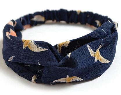 Women's retro style printed headband with colorful patterned fabric and twisted knot detail