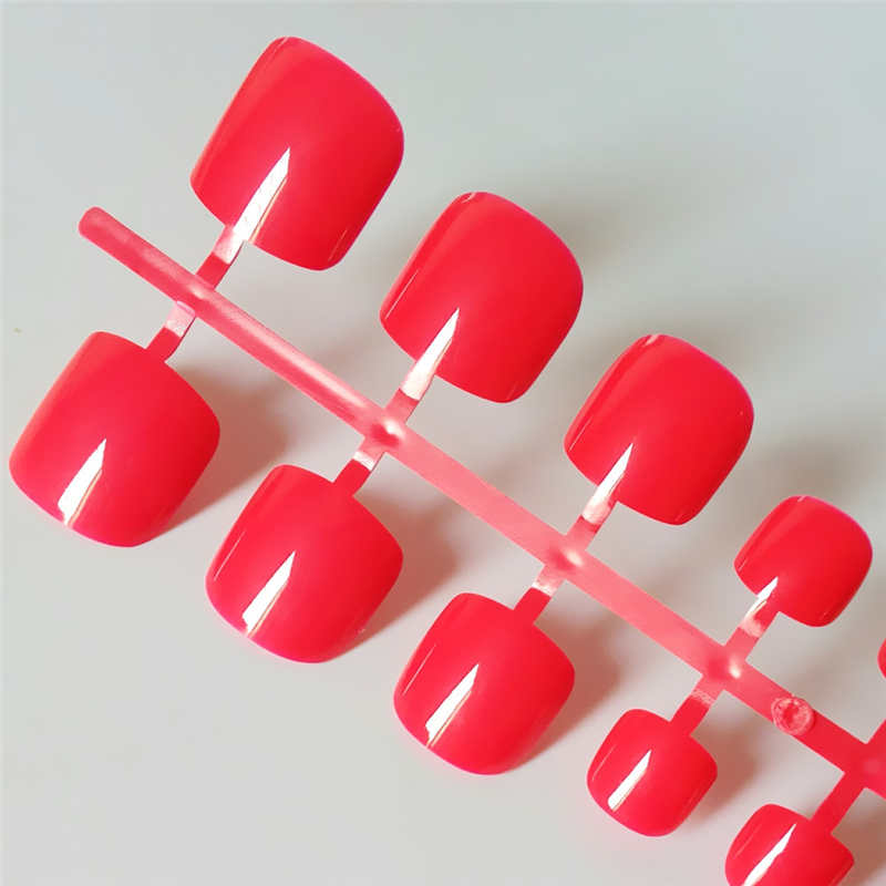 Bright green acrylic square press-on fake toenails displayed in a set