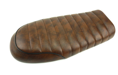 Export hump seat cushion saddle shown in a contoured design for improved rider comfort