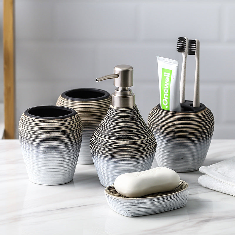 Retro brushed bathroom wash set with a vintage-style faucet and matching basin accessories in brushed metal finish
