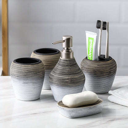 Retro brushed bathroom wash set with a vintage-style faucet and matching basin accessories in brushed metal finish