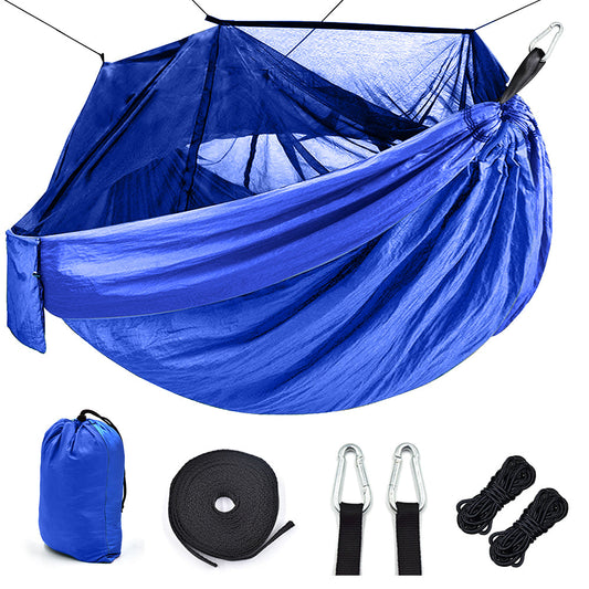 Outdoor camping hammock with mosquito net, suspended for relaxing in nature