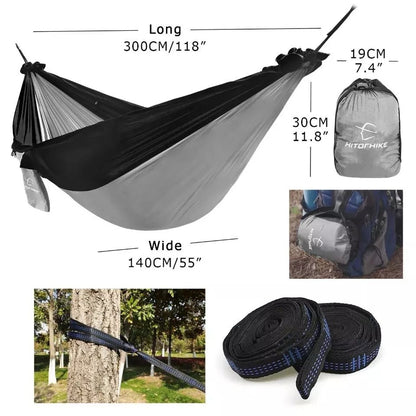 Portable nylon parachute outdoor double backpacking hammock suspended between trees