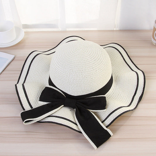 Women's foldable straw Panama sun hat with fashion bow, wide brim, and sunshade for beach travel