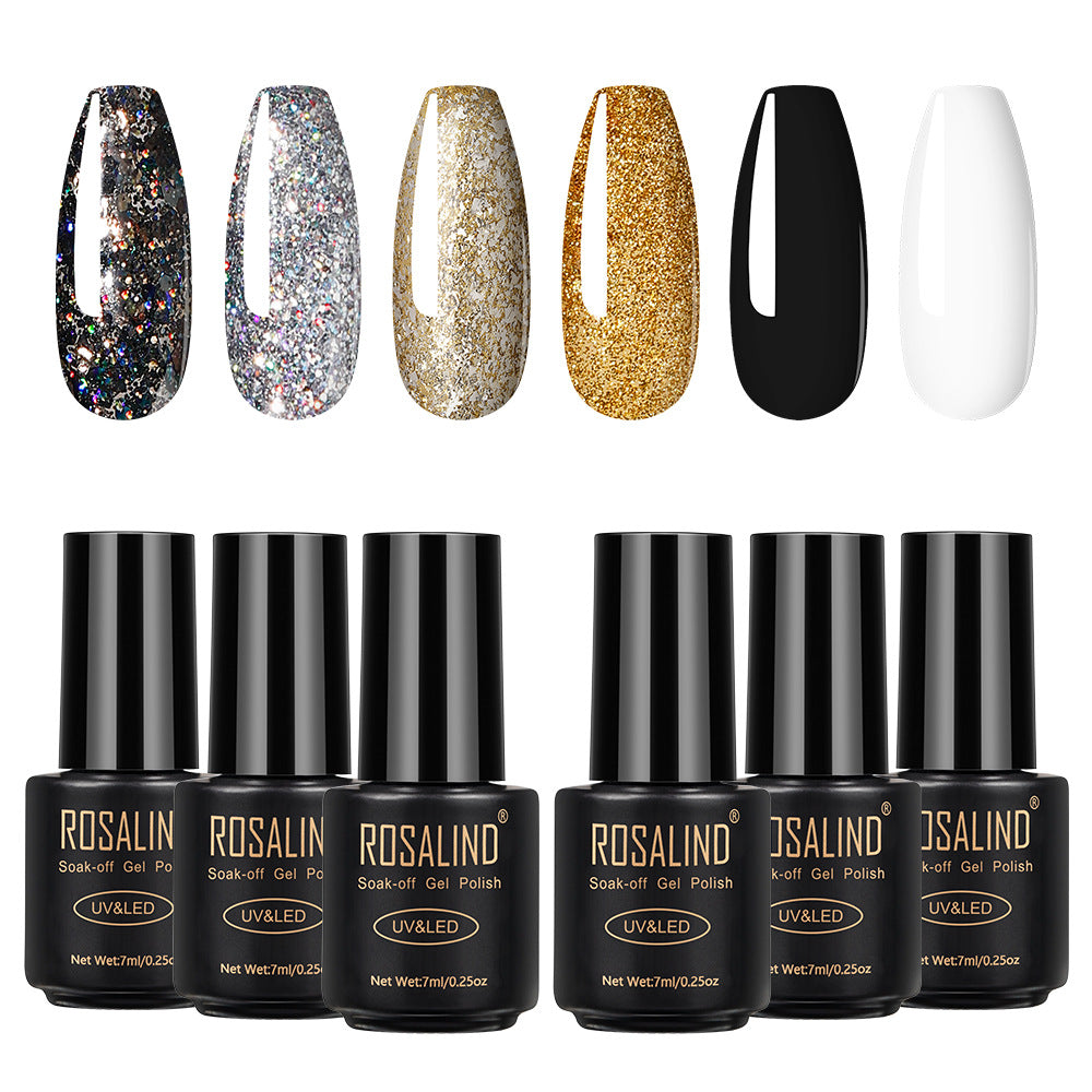 Six bottles of Fine nail polish in assorted colors arranged together