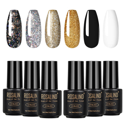 Six bottles of Fine nail polish in assorted colors arranged together