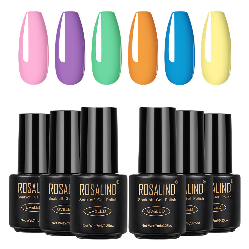 Six bottles of Fine nail polish in assorted colors arranged together