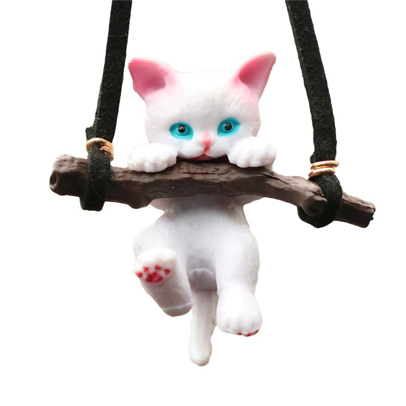 Cute branch cat car ornament pendant hanging from a rearview mirror