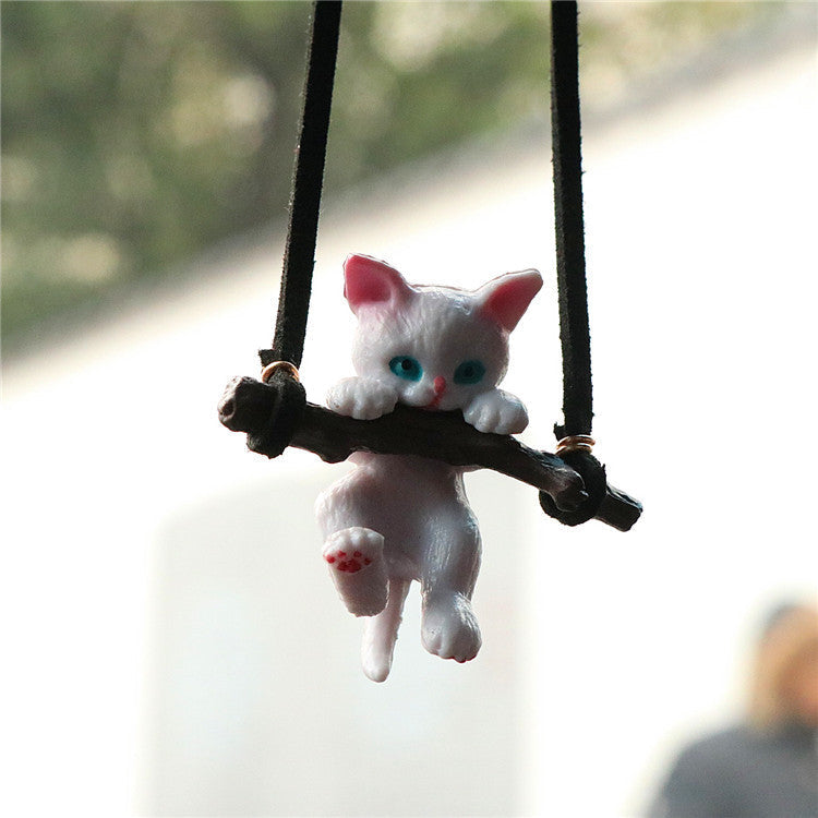 Cute branch cat car ornament pendant hanging from a rearview mirror