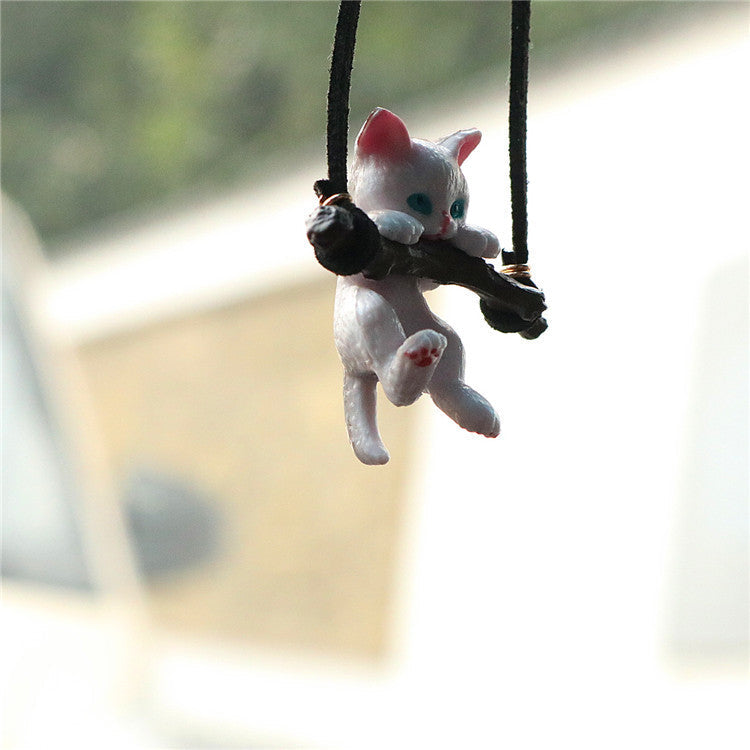 Cute branch cat car ornament pendant hanging from a rearview mirror