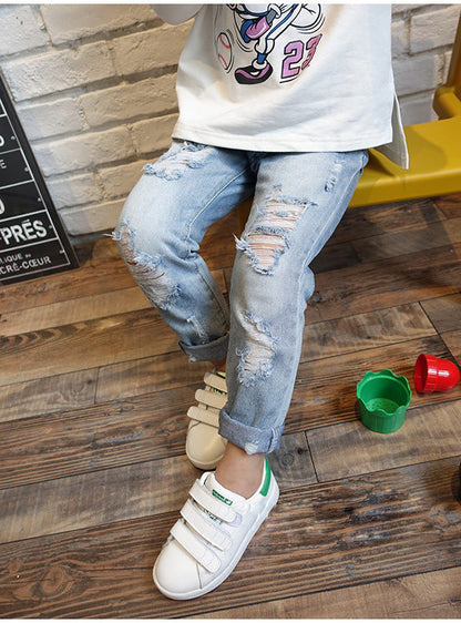 Korean style boys ripped trousers in a casual denim design