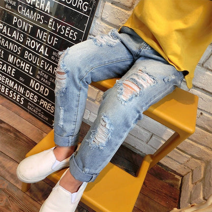 Korean-style boys' ripped trousers in a trendy distressed denim design