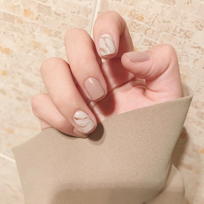 Light khaki smudge false nails with a subtle abstract design