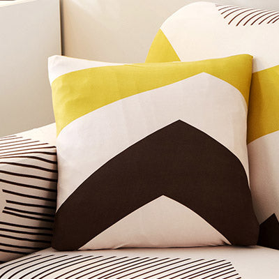 Printed sofa cushion cover with colorful patterned design visibly displayed on a sofa seat