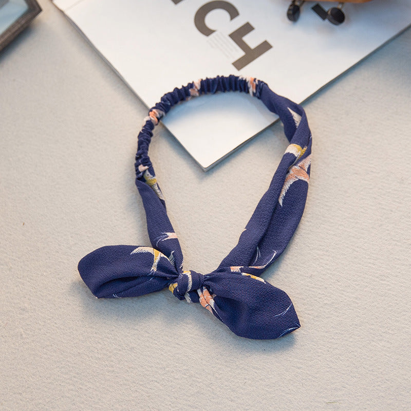 Big bow tie bunny ears headband in a playful design.